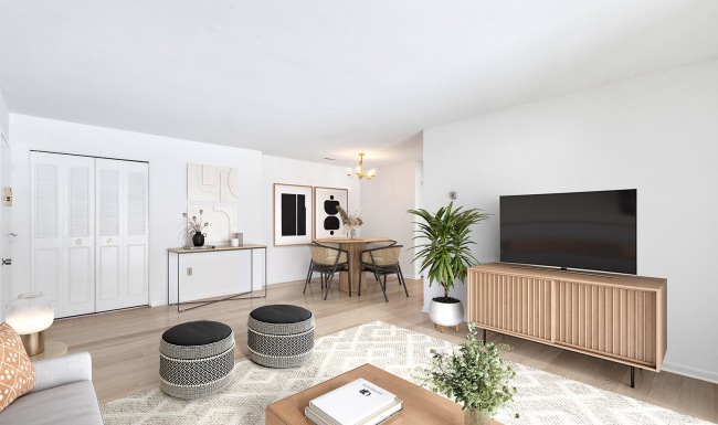 well lit living room open to dining area